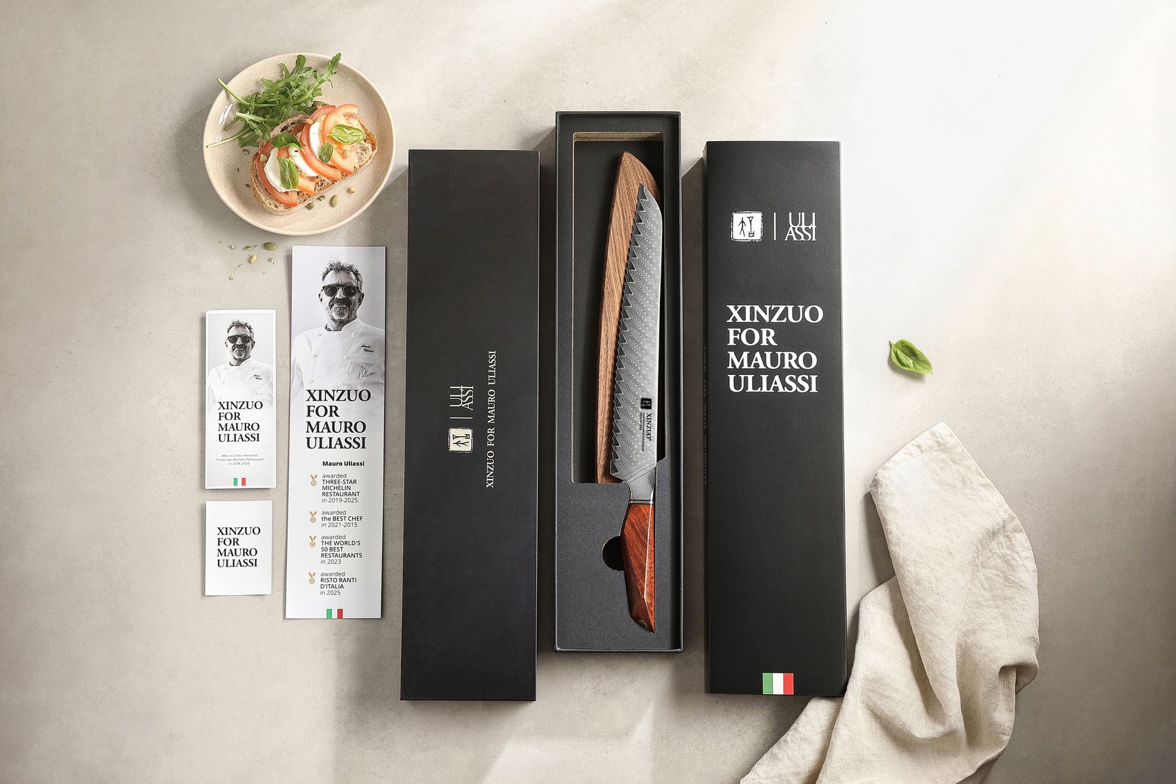 XINZUO for Mauro Uliassi bread knife in its black presentation gift box with collaboration cards