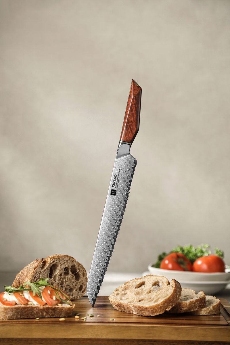 10-inch Damascus serrated bread knife with rosewood handle standing upright, full blade visible