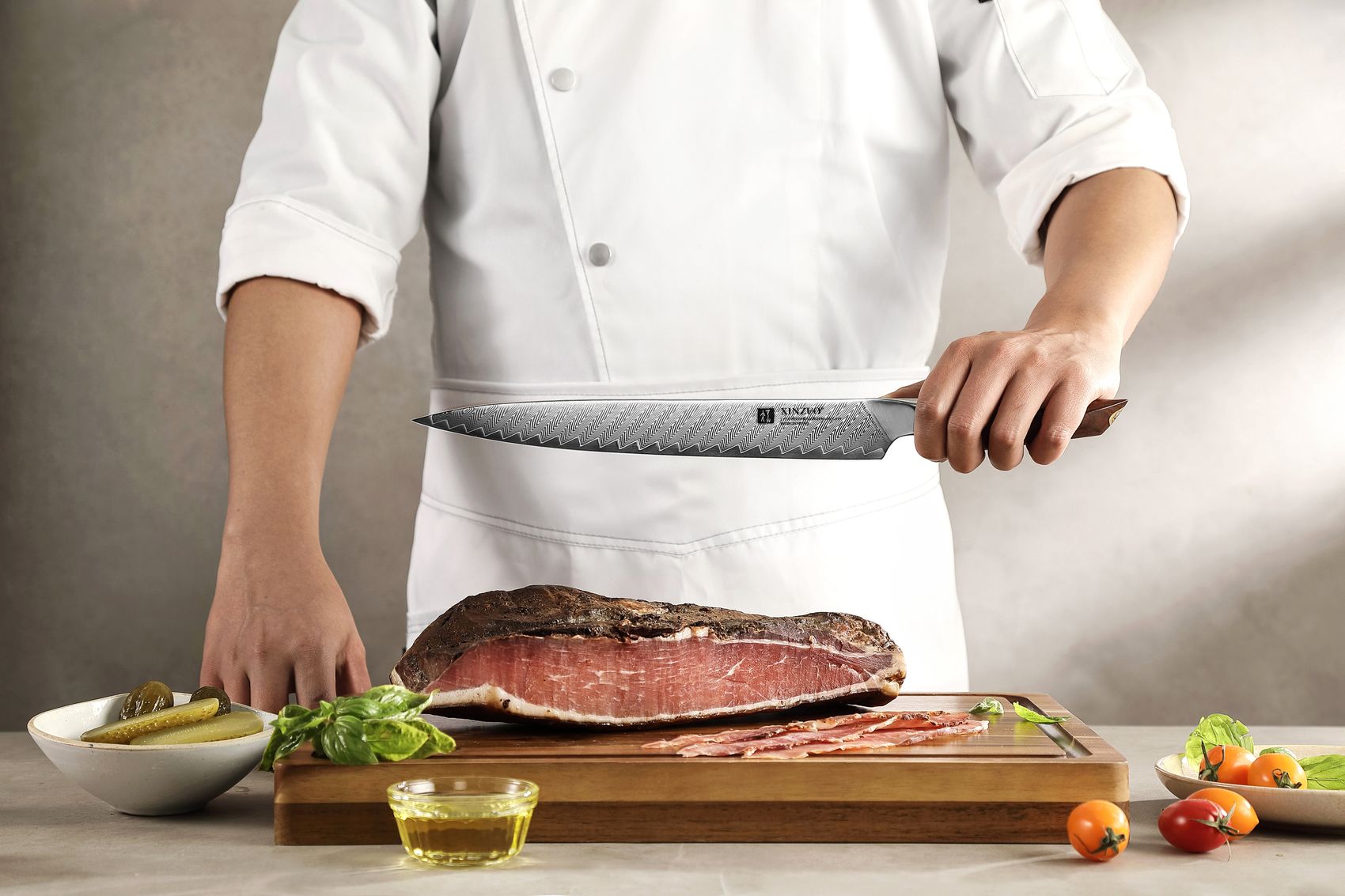 Chef carving a roast beef on a wooden board with the Damascus carving knife