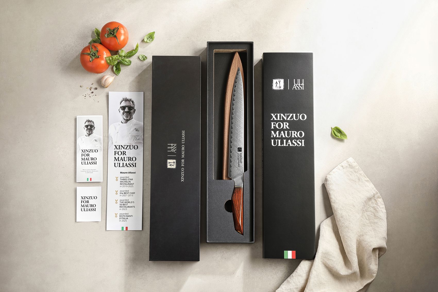 XINZUO for Mauro Uliassi carving knife in open black gift box with branded sleeve and chef cards