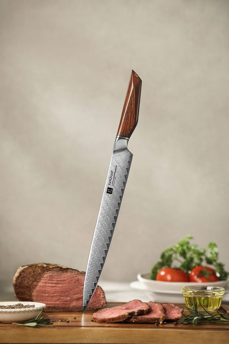 Studio shot of the Damascus carving knife standing upright showing patterned blade and rosewood handle