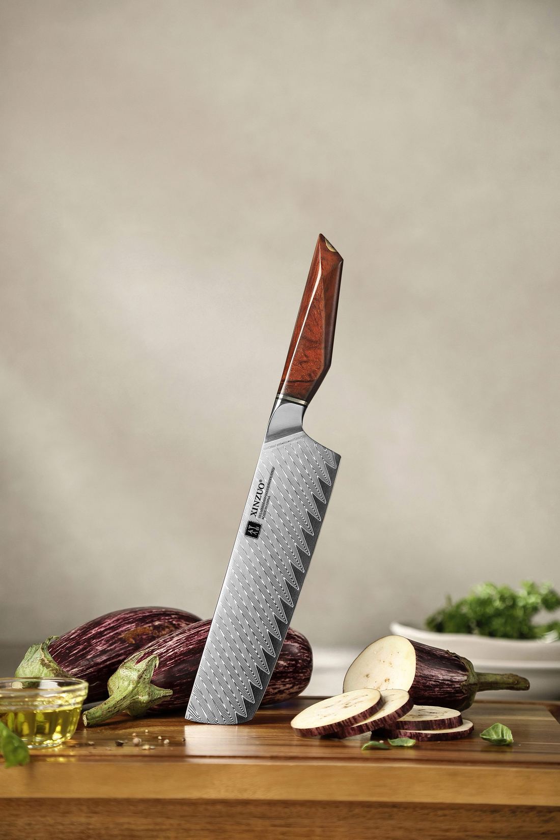 Close detail of the X03 Nakiri's wavy 73-layer Damascus, rosewood handle and brass mosaic pin