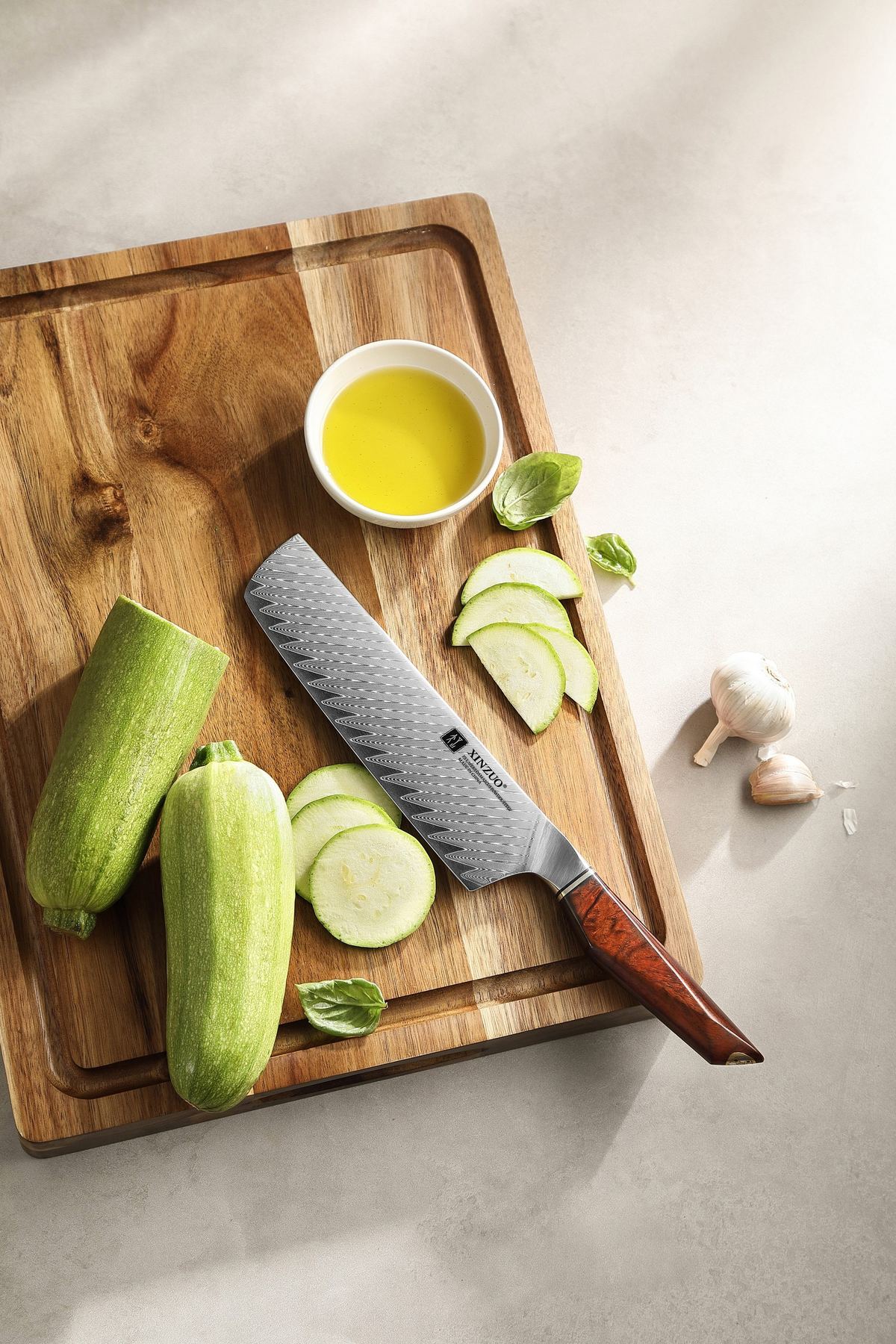 X03 Nakiri on a board with sliced zucchini, herbs and olive oil